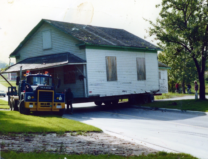 Photograph of the former church building arriving on site to be installed as the Guild Hall beside Burr House in September 1978.