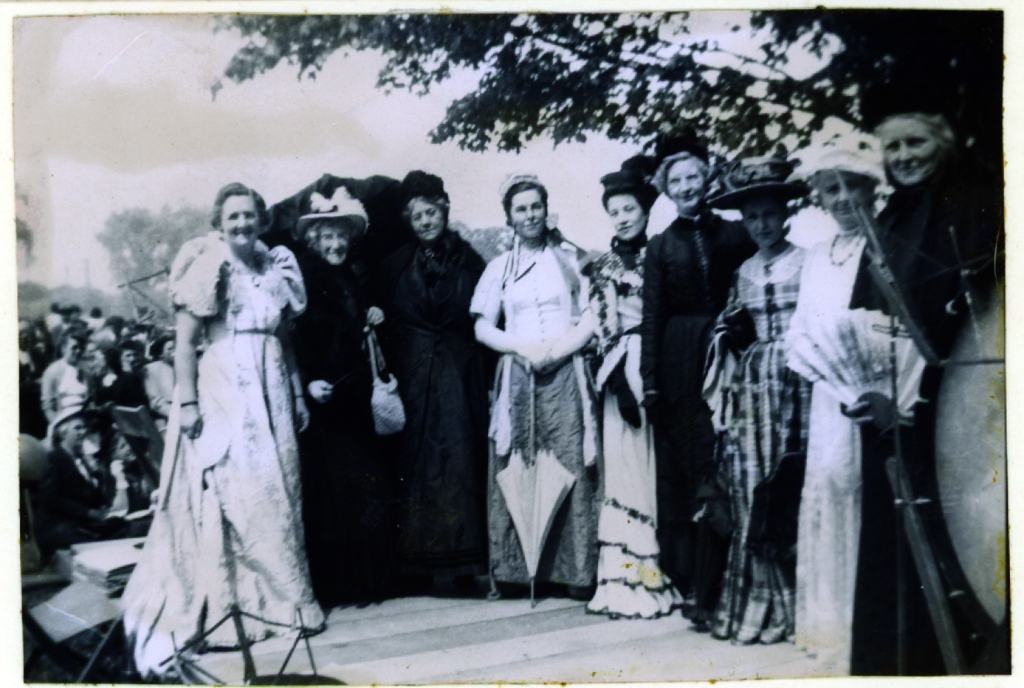 Members of the Richmond Hill Women's Institute in costume to commemorate the 100th anniversary of the Richmond Hill Agricultural Society, May 24, 1949. Left to right: Mrs. W. Sayers, Mrs. O.L. Wright, Mrs. J.P. Wilson, Mrs. H.H. Mackay, Mrs. Rabinovitch, Mrs. Blanchard, Mrs. Pipher, Mrs. N. Glass, Miss Annie Stong. (Richmond Hill Public Library, Tweedsmuir History Fonds, 080b)